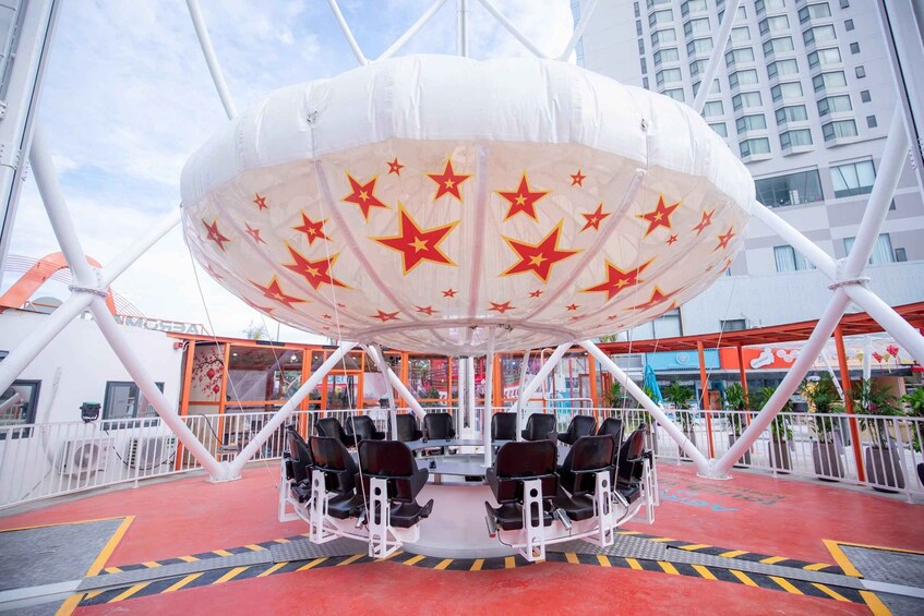 A ride with a white canopy decorated with red stars, black seats, and a red floor. 5