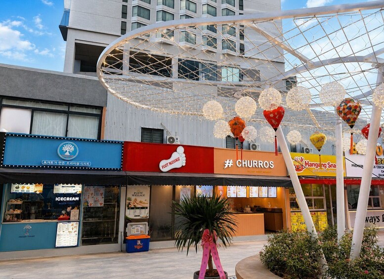 A food court with a churros stand, an ice cream shop, and a foot massage service. 3