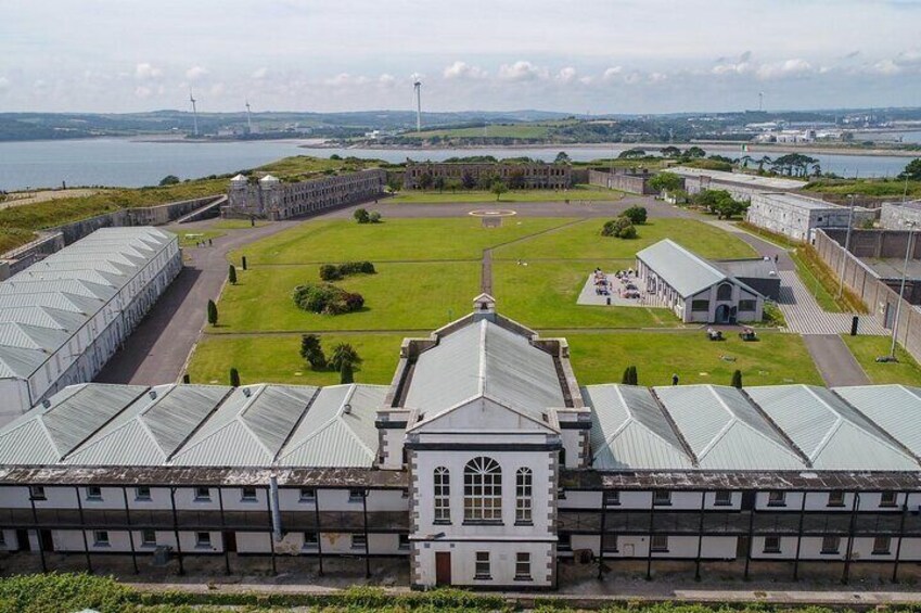 A large, historic building with a central courtyard, surrounded by a walled compound. 2