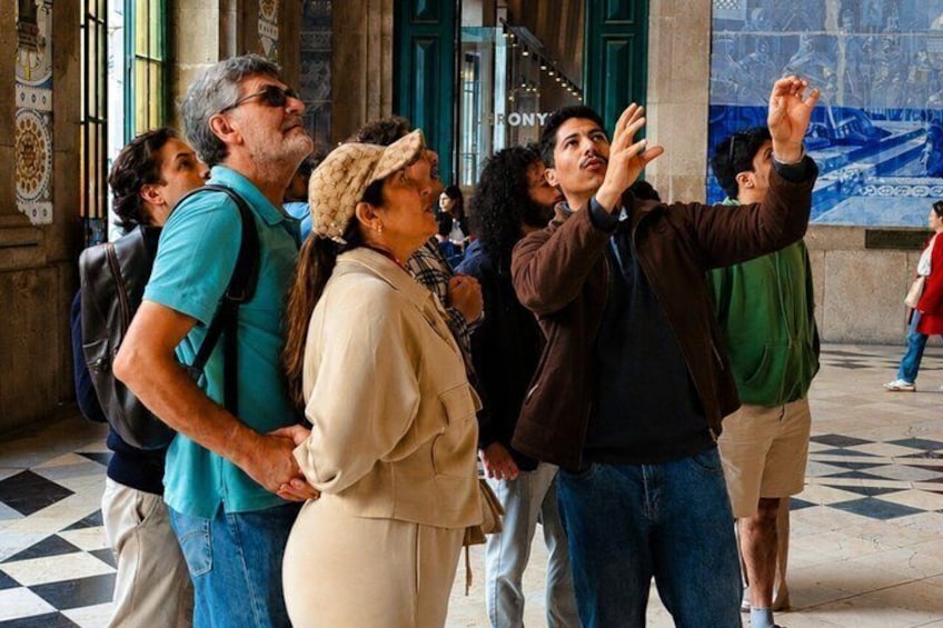 Tourists taking a photo in a historic building with columns and a tiled floor. 1