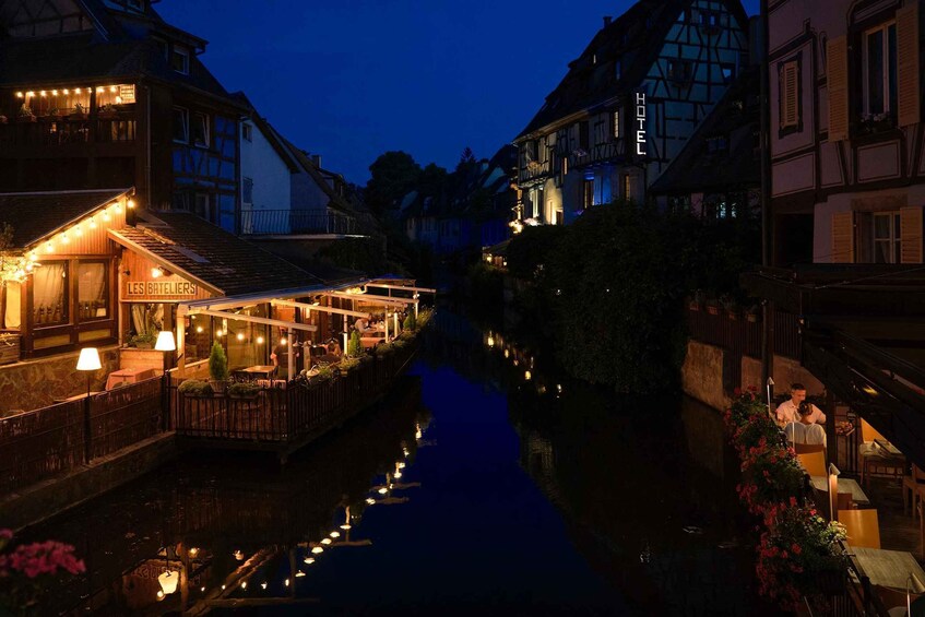 A canal with buildings on either side, including a hotel and a restaurant. 2