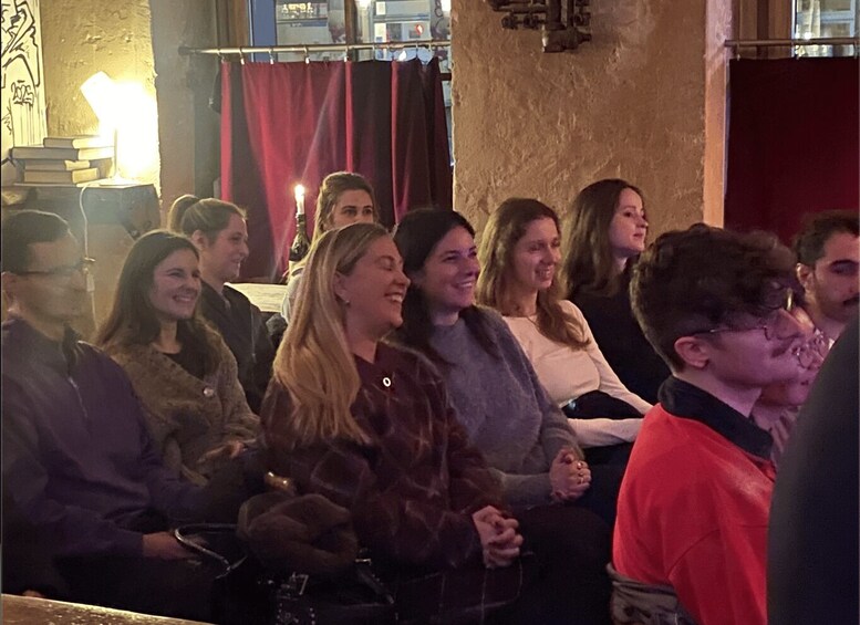 A group of people seated indoors, possibly at an event or gathering. 3