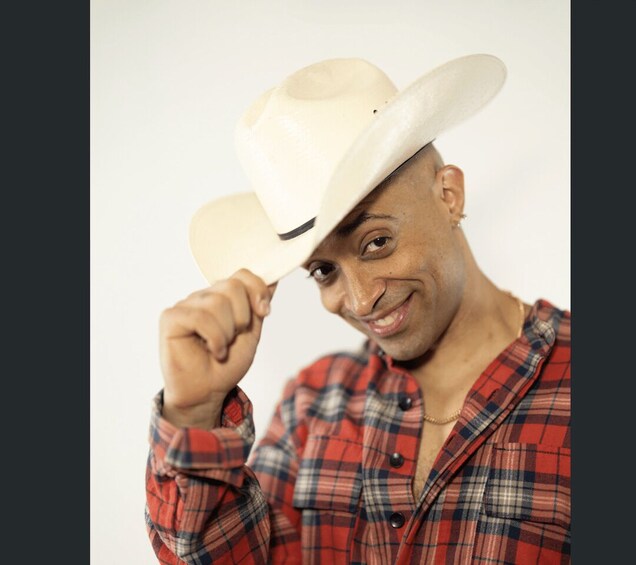 A person wearing a plaid shirt and holding a cowboy hat. 5