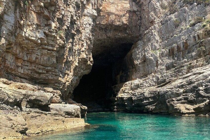 A natural rock formation with a water body at its base. 5
