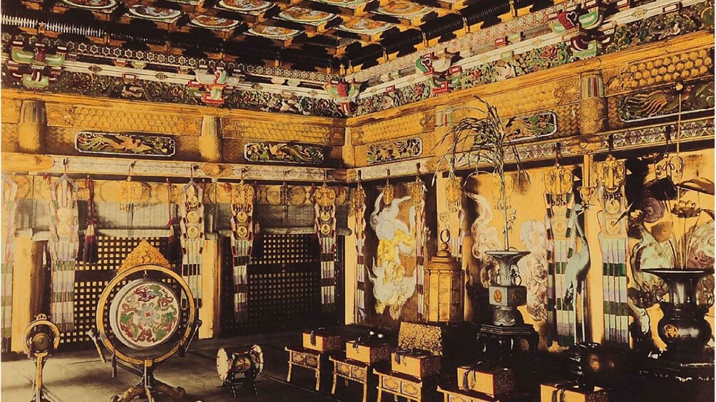 An ornate room with intricate wall carvings, a large mirror, and traditional furniture. 5