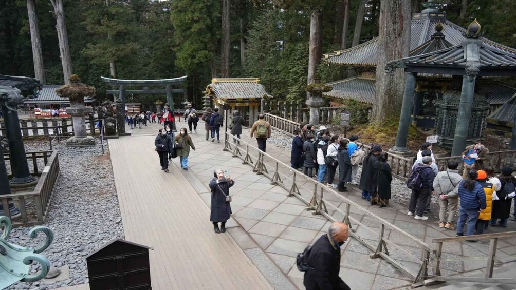 A traditional Japanese temple with visitors. 3