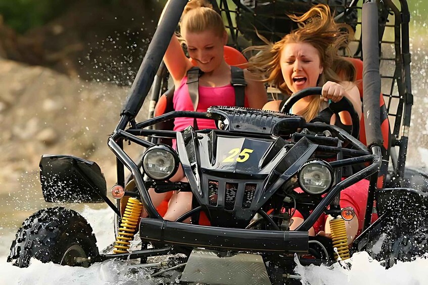 A vehicle with a number 25 on the front, water splashing around it, and two people inside. 5