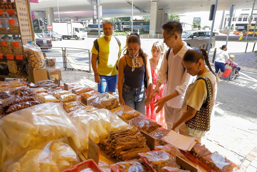A street market with various food items displayed on tables. 5