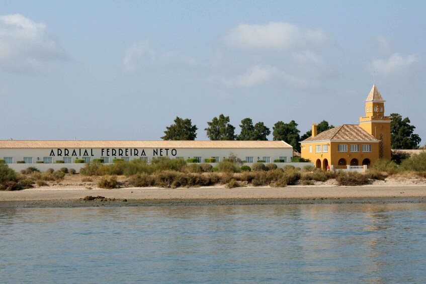 A building named 'Arraial Ferreira Neto' by the water. 3