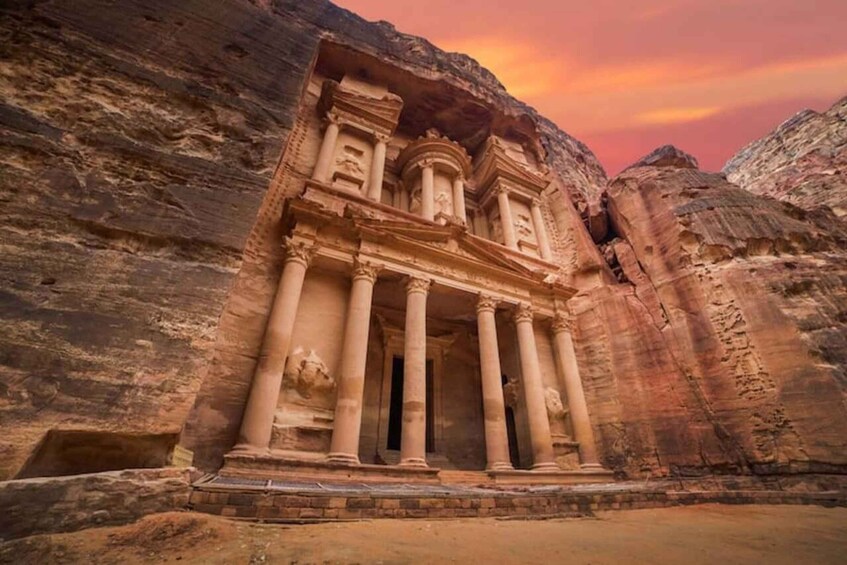 A rock-cut temple with columns and intricate carvings. 1