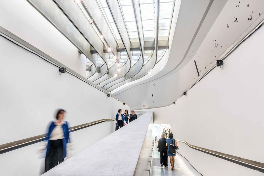 A modern interior with a curved staircase and a skylight. 3