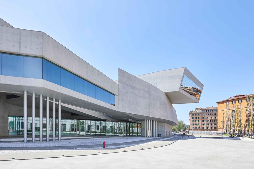 A modern architectural building with a curved facade and large windows. 1