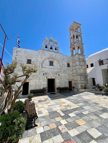 A historic building with a bell tower and a flag. 4