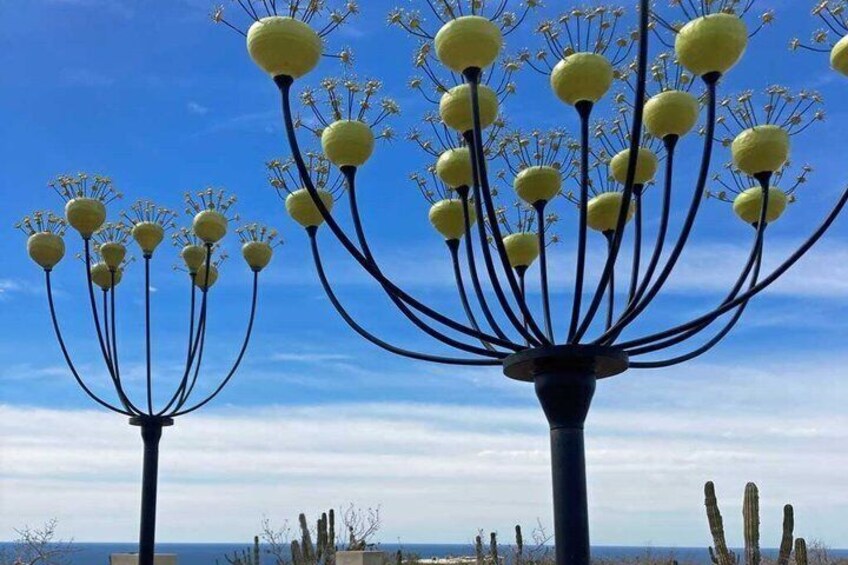 A sculpture with spherical elements and a blue sky. 2