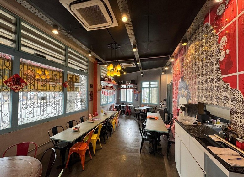 A restaurant interior with tables, chairs, decorative lights, and patterned walls. 5