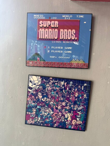 Two video game cartridges: 'Super Mario Bros.' and a crowded scene from a different game. 2