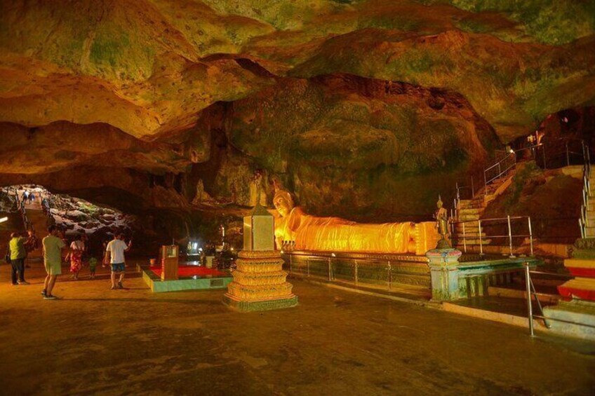 A cave with a statue and steps leading up to it. 4
