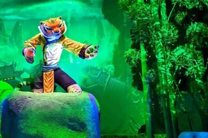 A tiger-like figure on a rock with a green forest background. 5