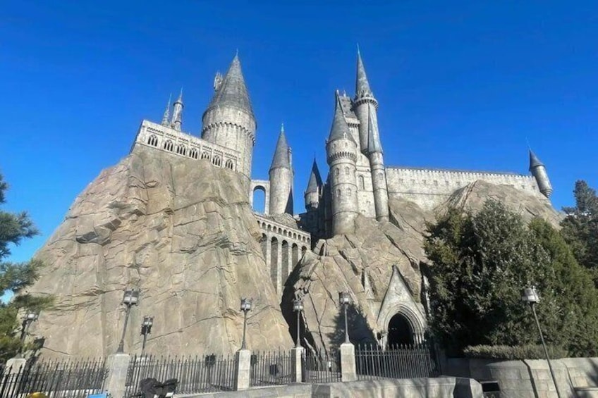A large castle-like structure with multiple towers and a prominent rock formation. 1