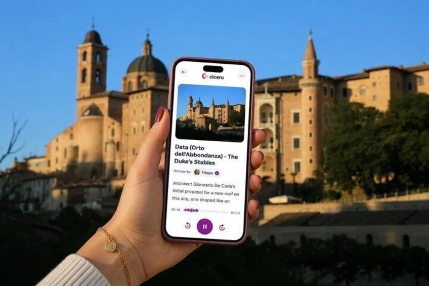 A hand holding a smartphone displaying a photo of a historic building with domes and towers. 1
