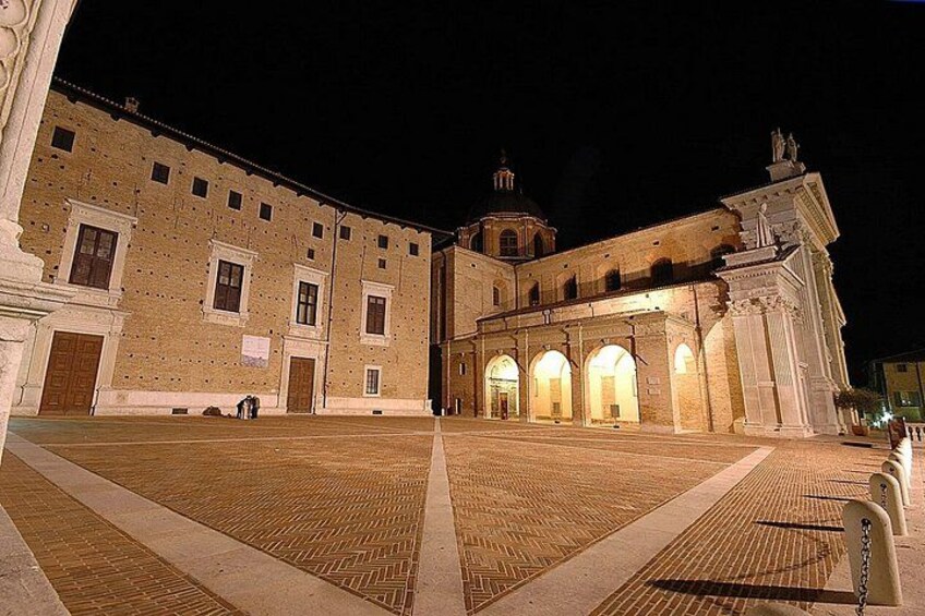 A historic building with arched windows and a central courtyard. 4