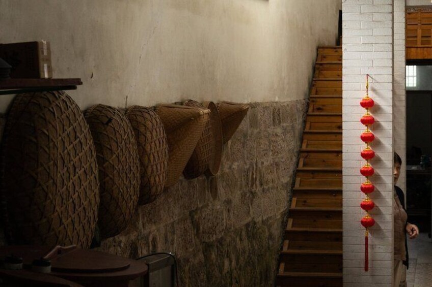 A staircase with wooden steps, a stone wall, and red lanterns. 2