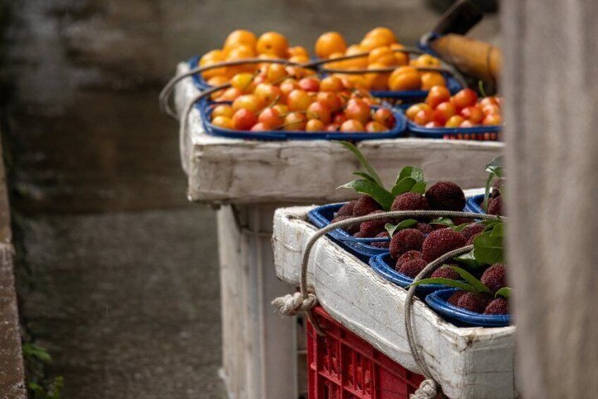 Fruit crates with oranges and possibly lychees. 4