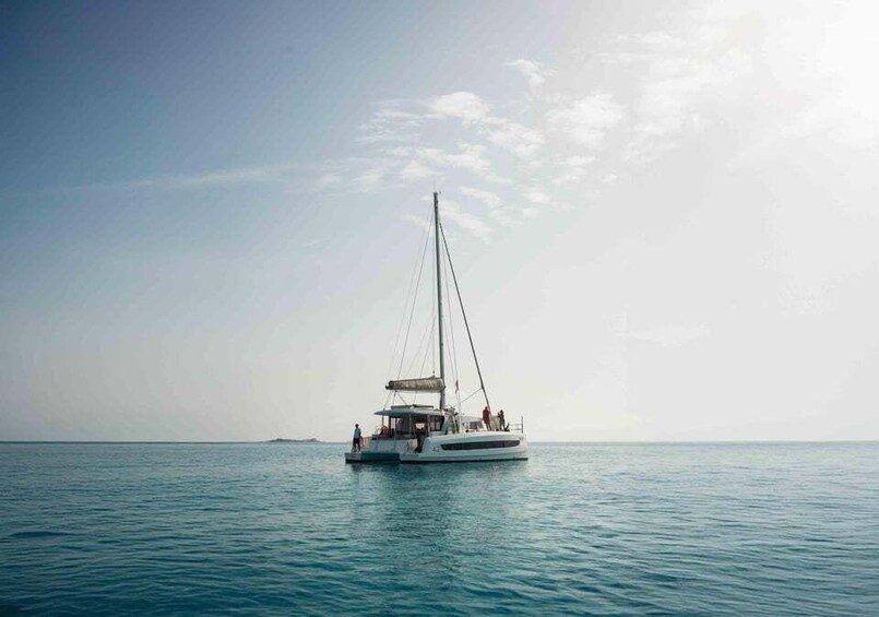 A sailboat on calm waters with a clear sky. 1