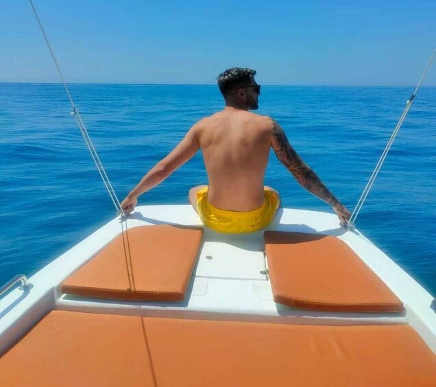 A person sitting on a boat with a view of the ocean. 4