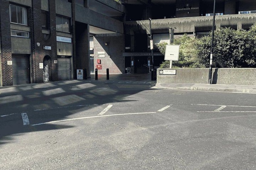 A parking lot with a building in the background. 3