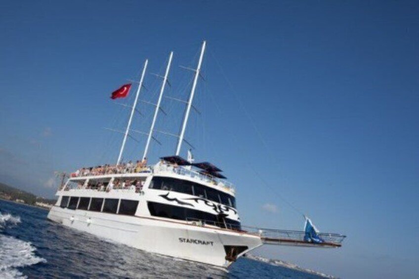 A large white yacht with multiple masts sailing on the water. 1