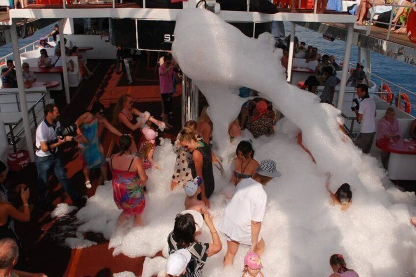 People playing with large foam balls on a boat. 5
