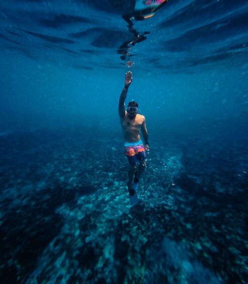 A person swimming underwater. 5