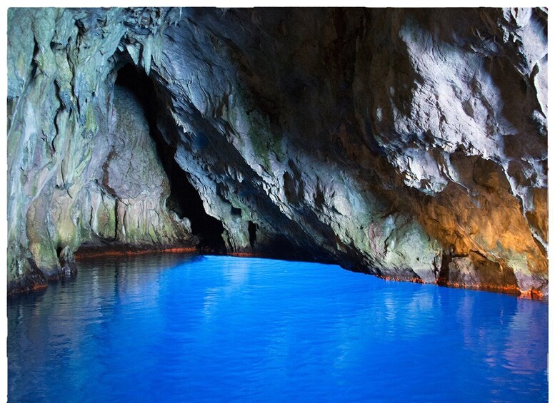 A cave with a pool of water reflecting the cave's interior. 5
