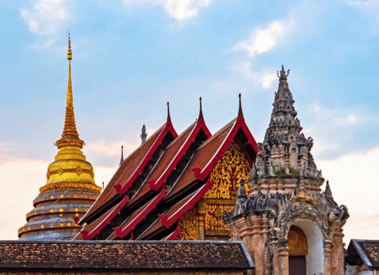 A temple with a golden spire and red-roofed structures. 4