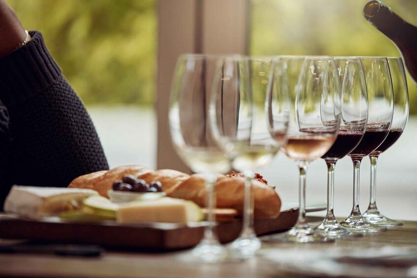 A table with wine glasses and a cheese board. 5