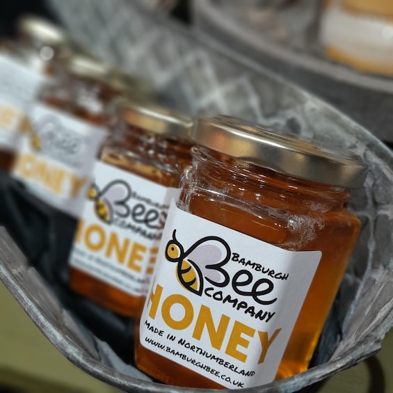 Jars of honey with labels in a basket. 1