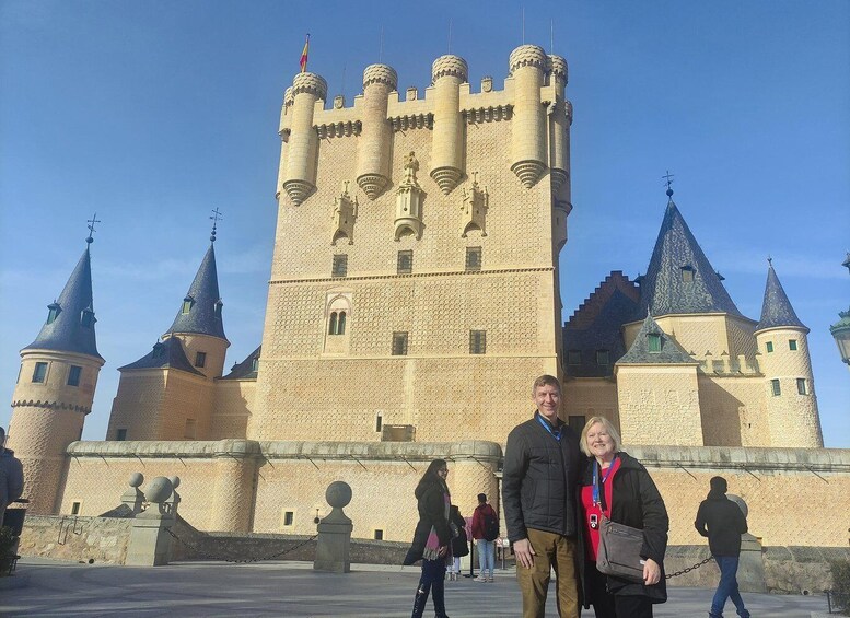 A historic castle with multiple towers and a clear sky. 1