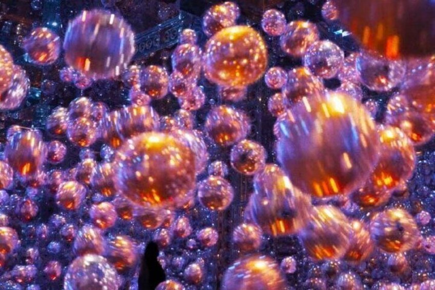 A close-up of spherical objects with a reflective surface, possibly metallic or glass, in a cluster. 4