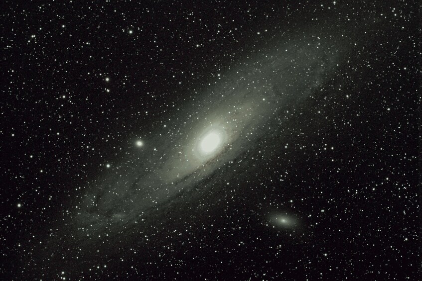 A galaxy with a bright core and surrounding stars. 5