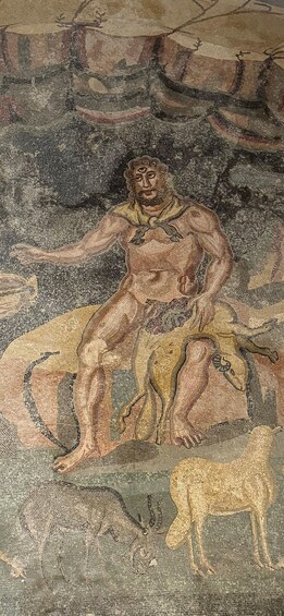 A mosaic with a seated figure, a dog, and a deer. 2