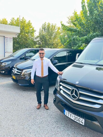 A man standing in front of a black Mercedes-Benz car with a license plate 'TY-3064'. 1