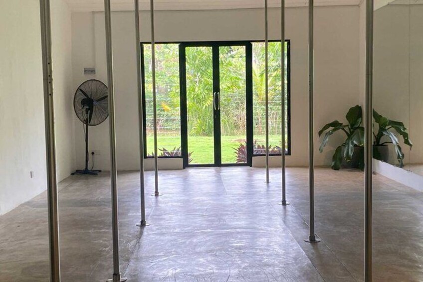 A spacious room with a large sliding glass door leading to a garden. 3