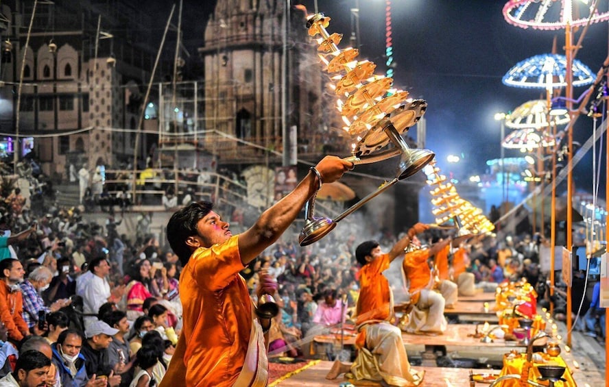 A person holding a large, ornate, golden object. 4