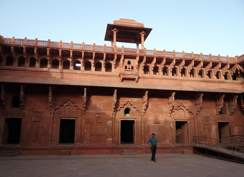 A large, ornate building with intricate carvings and a central open space. 2