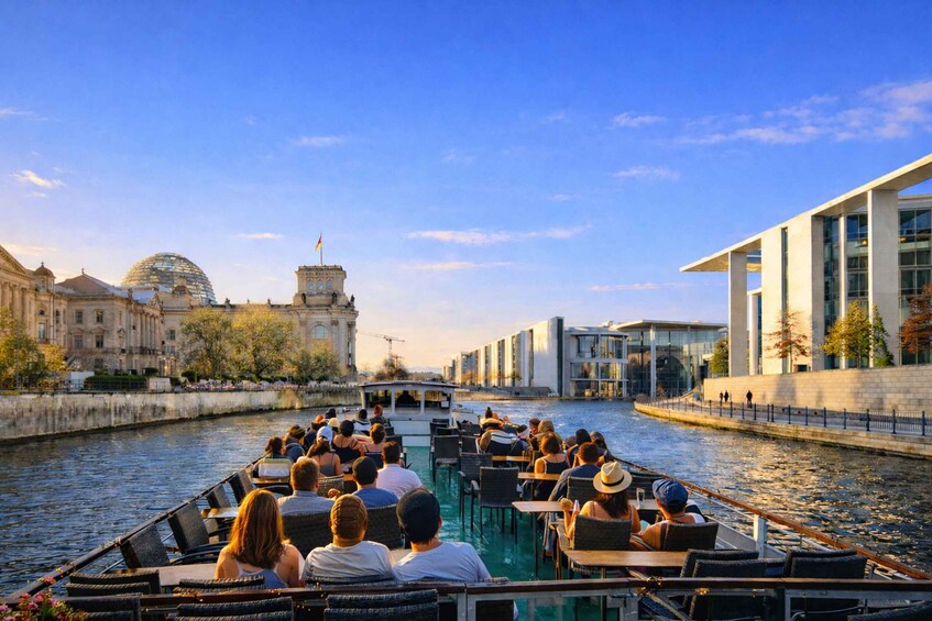 A river cruise with passengers enjoying the view of historic buildings and modern architecture. 2