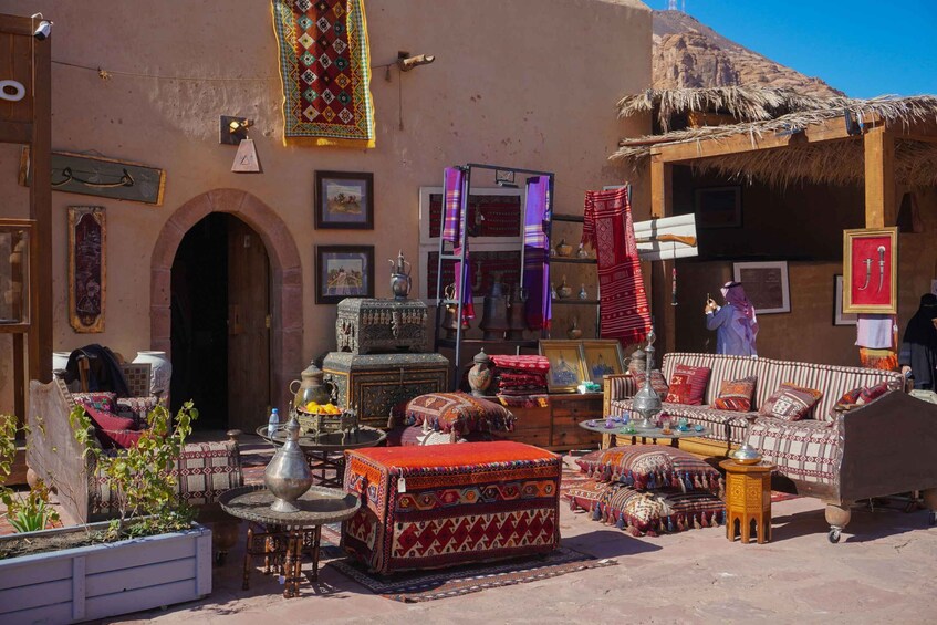 A traditional Moroccan courtyard with colorful textiles, furniture, and decorative items. 4