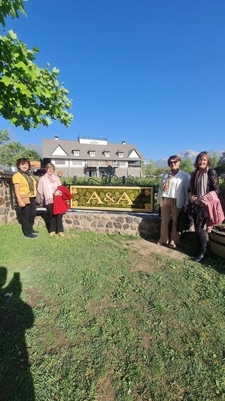 A group of people standing in front of a building with a sign that reads 'A & A.' 1