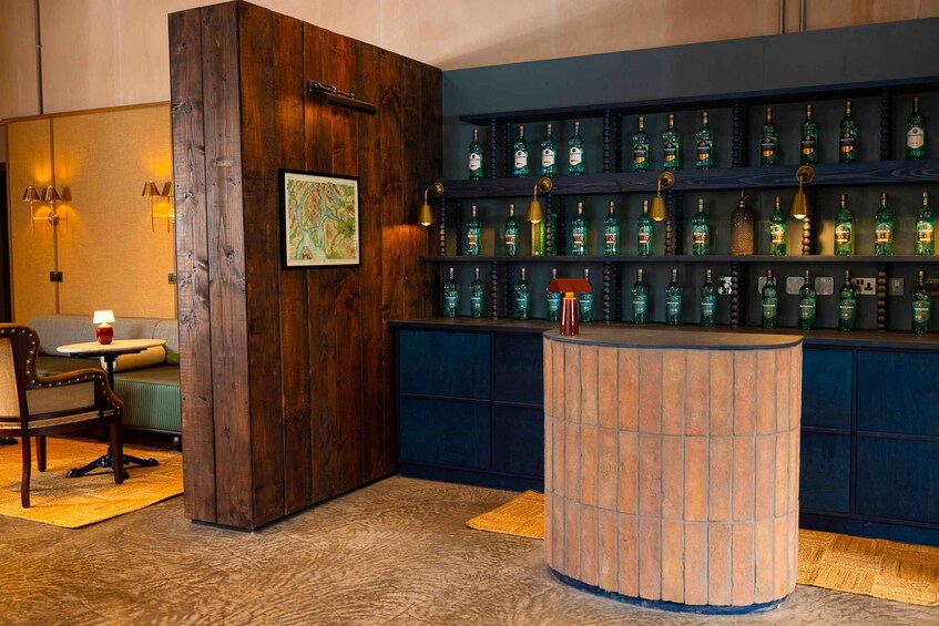 A bar area with wooden accents, a round counter, and shelves of liquor bottles. 3