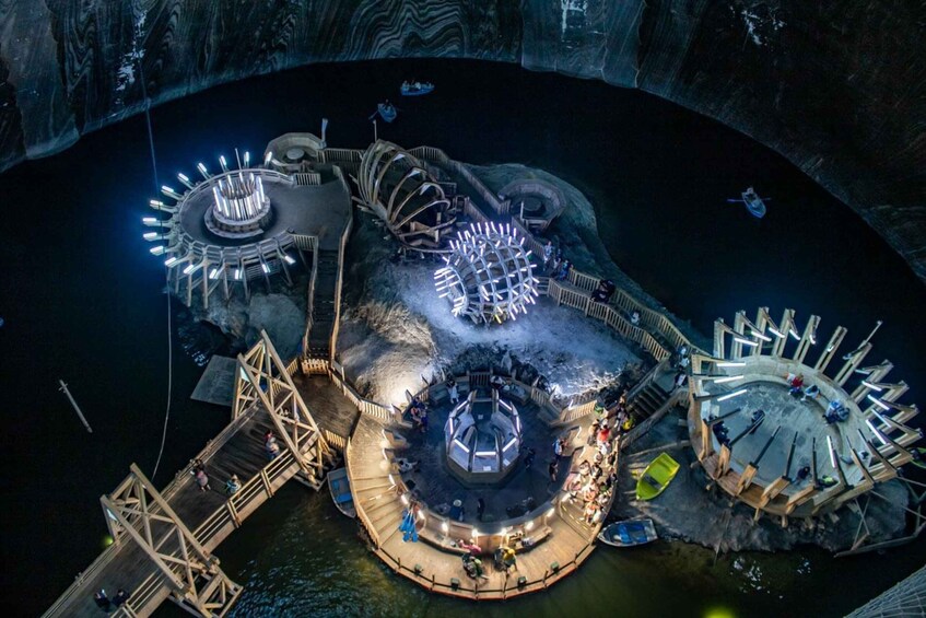 A large, illuminated water park with multiple circular structures and walkways. 1
